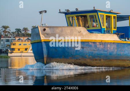 Closeup of bow on industrial river barge boat vessel traveling along large river in Africa Stock Photo