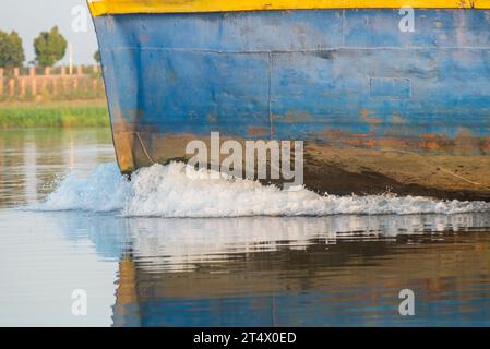 Closeup of bow on industrial river barge boat vessel traveling along large river in Africa Stock Photo