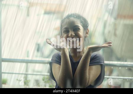 Girls Portraits in Rainy Season and Black And white Kids Background, little girl with cute Pout face, Two Sisters Enjoying the Rain, Two Girls in Rain Stock Photo