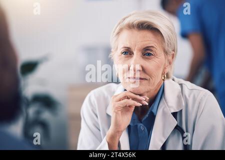 Face of mature woman, doctor and listening in consultation for healthcare support, communication and clinic services. Serious medical therapist Stock Photo