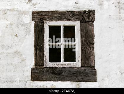 Antique old residential window frame on a white background with panes blacked out. Abstract background. Stock Photo
