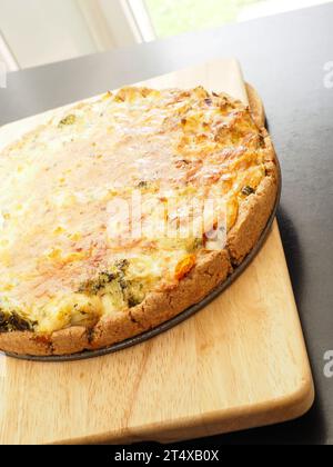 Tasty organic vegetable quiche on a cutting board in a kitchen, healthy eating or diet concept, vegetarian food Stock Photo