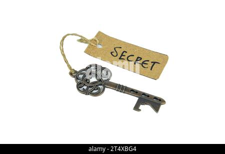 Antique old key with secret tag on white background Stock Photo