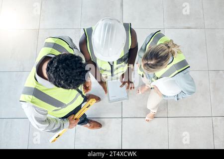 Teamwork, tablet or engineer construction workers working, collaboration on building project at construction site. Above innovation vision or Stock Photo