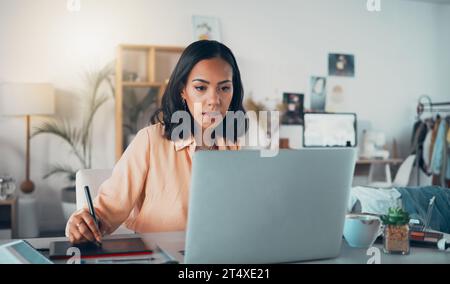 Laptop graphic designer, photo retoucher and freelance editor with interactive tablet, stylus or drawing equipment in studio. Serious, motivated and Stock Photo