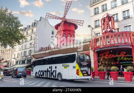 Contiki (18-35) tour bus in front of Moulin Rouge cabaret theatre, Place Blanche, Boulevard de Clichy, Pigalle District, Paris, Île-de-France, France Stock Photo