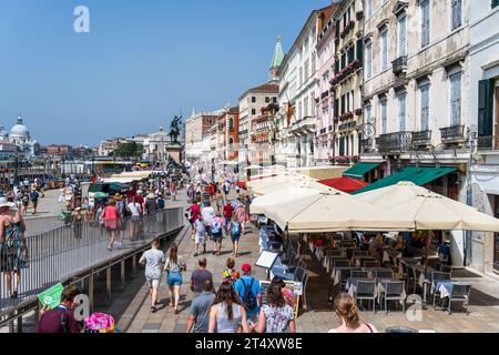 Tourists on Riva degli Schiavoni waterfront promenade in Venice, Veneto Region, Italy Stock Photo
