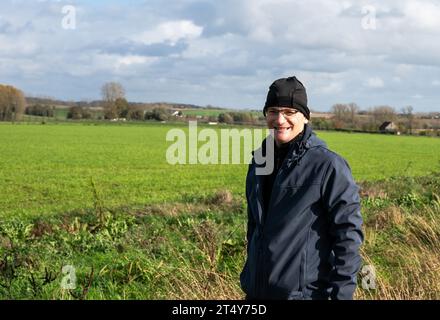 Active 45 yo white man with bonnet standing in the green fields around Gooik, Brabant, Belgium Stock Photo