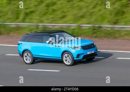 2022 Blue Land Rover R Rover Velar R-Dyn Hse Phev A P400e 404 PHEV 300Hp + 143Hp Motor 13.6Kw Battery Auto Start/Stop Hybrid Electric SUV ; driving on the M6 Motorway, Manchester, UK Stock Photo