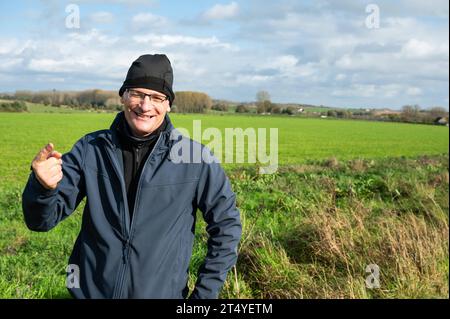 Active 45 yo white man with bonnet standing in the green fields around Gooik, Brabant, Belgium Credit: Imago/Alamy Live News Stock Photo