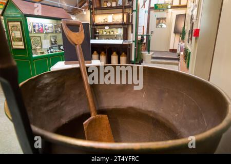 Jam boiling pan & wooden paddle (stirring) in the Jam Museum at Wilkin & Sons Limited, manufacturer of preserves since 1885, Tiptree, Essex, UK. (136) Stock Photo