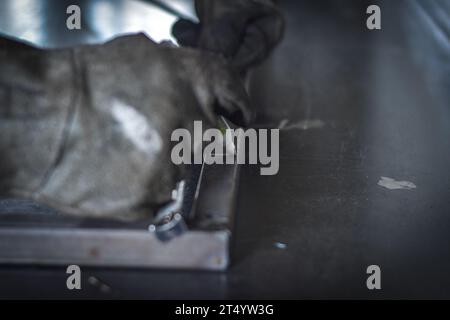 Man measuring off metal bar in industrial workshop. near Kocani Macedonia Stock Photo