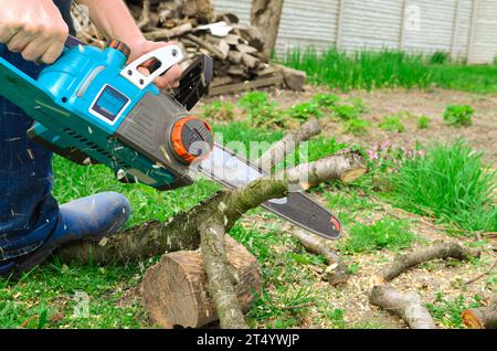 Working with Power Tools. An electric saw in the hands of a man. Stock Photo