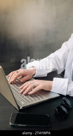 Professional Businesswoman Analyzing Strategy in Office. Laptop and Workroom Scene. Business woman professional work in the office, analyzing business Stock Photo