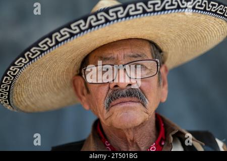 An elderly Mexican cowboy taking part in the annual four-day Cabalgata de Cristo Rey cowboy pilgrimage on horseback poses for a portrait, January 5, 2019 in Salamanca, Guanajuato, Mexico. Thousands of Mexican cowboys and their horses join the religious journey from the high desert villages to the mountaintop shrine of Cristo Rey. Stock Photo