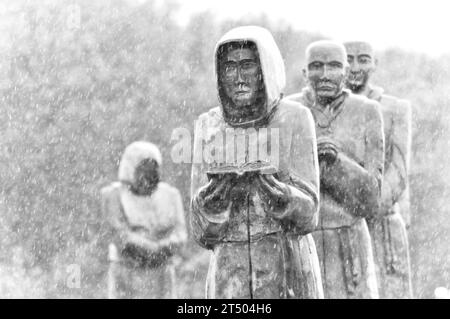 Life size, carved wooden sculptures of the Monks of Meaux (Hull) East Yorkshire, in procession on a wet day in October Stock Photo