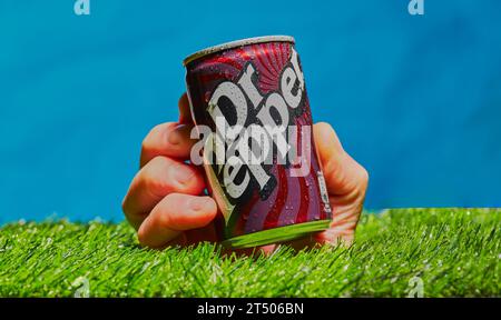Mansfield,Nottingham,United Kingdom,November 2023:Studio product image of a hand holding a can of Dr Pepper soft drink. Stock Photo