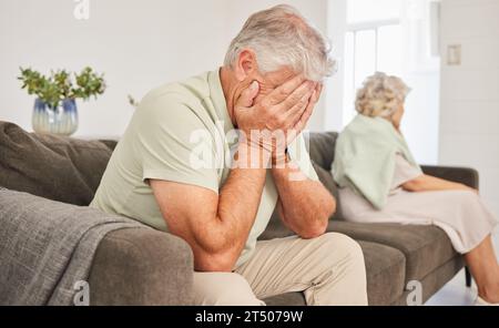 Man, sad and crying in fight, divorce and stress of breakup, shame and mistake on sofa. Frustrated, depression and emotional couple in conflict Stock Photo