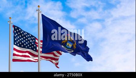 Michigan state flag and national american flag waving in the wind on a clear day. Pride and patriotism concept. 3d illustration render. Rippling fabri Stock Photo