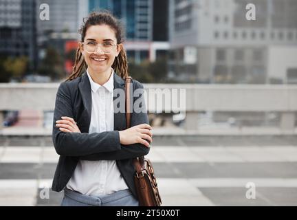 Business woman, smile portrait and arms crossed outdoor, happy from job pride as a worker. City, entrepreneur and work commute travel with Stock Photo