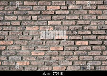Brick wall facade. Abstract background photo. Lovely plastic texture facing on the building. Ideal for placement of text. Stock Photo