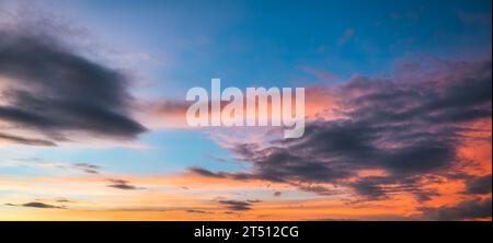 Panorama of beautiful dramatic vibrant colorful sky and cloud during golden hour at the sunset Stock Photo