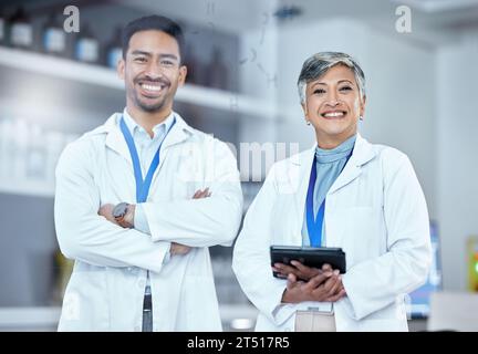 Science, tablet and portrait of a team of scientists standing with confidence in laboratory. Happy, medical and scientific researchers with digital Stock Photo