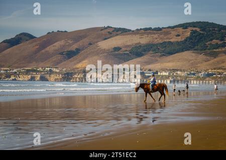 Pismo Beach, California, USA - October 31, 2023.  A picturesque scene of a California mounted patrol unit, comprised of uniformed officers on horsebac Stock Photo