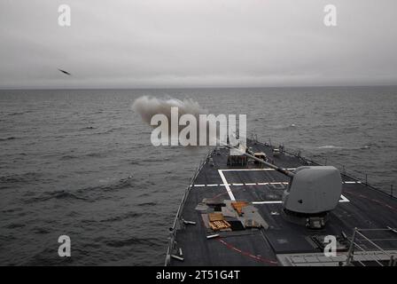 0910131688B-011 ATLANTIC OCEAN  (Oct. 13, 2009) A 5-inch/54-caliber (Mk 45) lightweight gun is fired aboard the guided-missile destroyer USS Cole (DDG 67) during a live fire exercise. Cole is participating in Exercise Joint Warrior 09-2, a United Kingdom-led, multinational exercise designed to improve interoperability between allied navies as well as to prepare for a role in combined operations during upcoming deployments. Navy Stock Photo