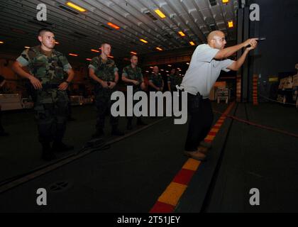 0707198909B-089 PERSIAN GULF (July 19, 2007) - Naval Criminal Investigative Service (NCIS), Special Agent Edward Jones, right, conducts training during a small team tactics training exercise aboard amphibious assault ship USS Bonhomme Richard (LHD 6). The shipХs masters-at-arms held training to ensure they can respond to any type of hostile incident on board. Bonhomme Richard Expeditionary Strike Group is operating in the 5th Fleet area of operations conducting Maritime Operations. U.S. Navy Stock Photo