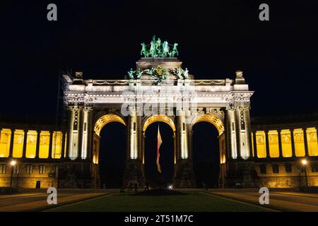Triumphal Arch, triple memorial arch topped with a quadriga illuminated at night, Parc du Cinquantenaire, Brussels, Belgium Stock Photo
