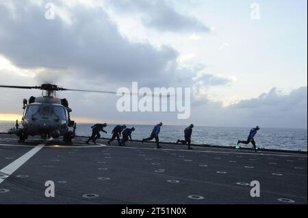 1012018335D-249 PACIFIC OCEAN (Dec. 1, 2010) Sailors run to safety aboard the amphibious dock landing ship USS Tortuga (LSD 46) after chocking and chaining a U.S. Air Force HH 60-G Pave Hawk helicopter assigned to the 33rd Rescue Squadron. Tortuga is part of the permanently forward-deployed Essex Amphibious Ready Group and is underway in the western Pacific Ocean. Navy Stock Photo