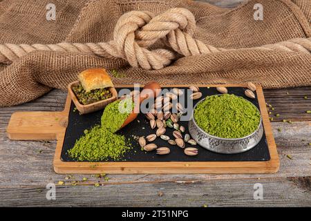 Pistachio powder. Ground, milled, crushed or granulated pistachio pile from top view. Stock Photo
