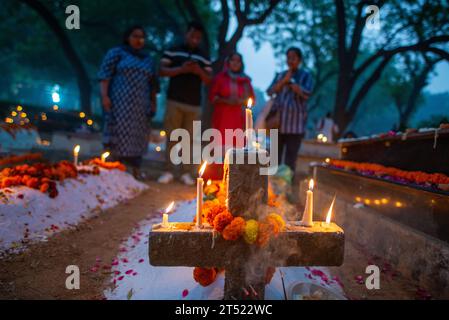 New Delhi, India. 02nd Nov, 2023. A family is seen lighting candles and praying on the grave of their relative during the All souls day observation at Delhi Cantonment Christian Cemetery. All Souls' Day on November 2nd is a Christian tradition to pray for departed souls, especially those in Purgatory, through church services, prayers, and cemetery visits, with the hope of their ultimate salvation. (Photo by Pradeep Gaur/SOPA Images/Sipa USA) Credit: Sipa USA/Alamy Live News Stock Photo