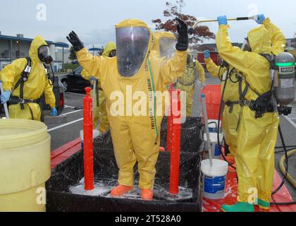 0910289860Y-006 OAK HARBOR, Wash. (Oct. 28, 2009) Navy Region Northwest Fire and Emergency Services and Oak Harbor Fire Department personnel decontaminate the Navy Region Northwest Fire and Emergency Services initial entry team during an Installation Protection Program, Guardian full-scale exercise on Naval Air Station Whidbey Island. The exercise tested various base capabilities in response to an unknown chemical, biological, radiological, or nuclear threat that has the potential to endanger installation personnel, facilities and assets. Navy Stock Photo