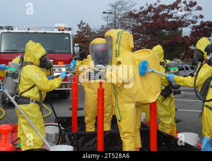 0910289860Y-005 OAK HARBOR, Wash. (Oct. 28, 2009) Navy Region Northwest Fire and Emergency Services and Oak Harbor Fire Department personnel decontaminate the Navy Region Northwest Fire and Emergency Services initial entry team during an Installation Protection Program, Guardian full-scale exercise on Naval Air Station Whidbey Island. The exercise tested various base capabilities in response to an unknown chemical, biological, radiological or nuclear threat that has the potential to endanger installation personnel, facilities and assets. Navy Stock Photo