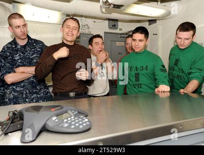 1012297095C-054 ARABIAN SEA (Dec. 29. 2010) Sailors aboard the aircraft carrier USS Abraham Lincoln (CVN 72) speak with Boston Bruins goalie Tim Thomas during a phone call from the hockey player to the aircraft carrier. Thomas' phone call is the latest in a series of recent calls from prominent Boston sports figures to Abraham Lincoln sports fans. The Abraham Lincoln Carrier Strike Group is deployed in the U.S. 5th Fleet Area of Responsibility conducting maritime security operations and theater security cooperation efforts. Navy Stock Photo