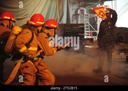 110127VF447-017 NEWPORT NEWS, Va. (Jan. 27, 2011) Sailors assigned to the in-port emergency team aboard the aircraft carrier USS Theodore Roosevelt (CVN 71) train to extinguish a class alpha fire. Theodore Roosevelt is undergoing a mid-life refueling complex overhaul at Northrop Grumman Newport News Shipbuilding. Navy Stock Photo