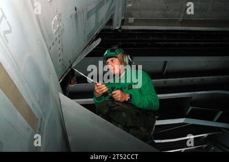 0912203327M-004 NORTH ARABIAN SEA (Dec. 20, 2009) Airman Josh Deresner assigned to the Sidewinders of Strike Fighter Squadron (VFA) 86, removes a rudder from an F/A-18C Hornet for maintenance aboard the aircraft carrier USS Nimitz (CVN 68). Nimitz Carrier Strike Group is on a routine deployment to the U.S. 5th Fleet area of responsibility. Navy Stock Photo