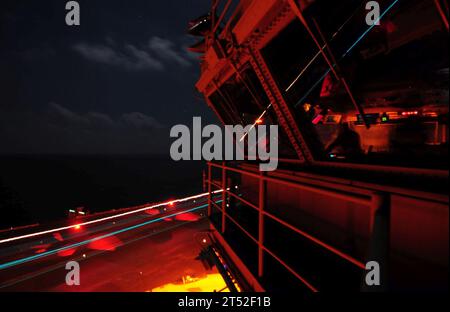 110809SB672-086 SOUTH CHINA SEA (Aug. 9, 2011) Sailors observe from the primary flight control tower as an F/A-18 Hornet lands aboard the aircraft carrier USS Ronald Reagan (CVN 76). Ronald Reagan is underway in the U.S. 7th Fleet area of responsibility. Navy Stock Photo