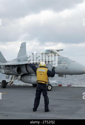 1002034408B-214  ATLANTIC OCEAN (Feb 3, 2010) A Sailor, assigned to the air department of the aircraft carrier USS George H.W. Bush (CVN 77), directs an F/A-18C Super Hornet from Strike Fighter Squadron (VFA) 15 during flight operations. George H.W. Bush, the Navy's 10th and final Nimitz-class aircraft carrier, is underway in the Atlantic Ocean conducting flight deck certification. Navy Stock Photo