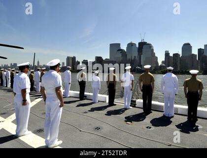 1105252147L-004 NEW YORK (May 25, 2011) Sailors and Marines aboard the amphibious transport dock ship USS New York (LPD 21) pay tribute during a parade of ships in the New York Harbor. New York has 7.5 tons of steel salvaged from the World Trade Center towers forged into her bow and is participating in the 24th annual Fleet Week New York. Navy Stock Photo