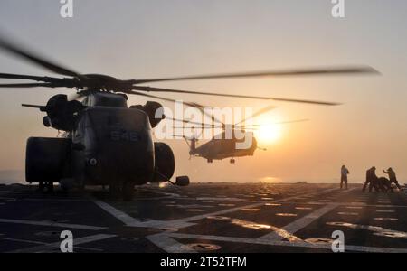 1012013620B-017 EAST CHINA SEA (Dec. 1, 2010) An MH-53 Sea Stallion helicopter assigned to the Vanguard of Mine Countermeasures Squadron (HM) 14 prepares to shutdown its engines as another Sea Stallion helicopter prepares to land aboard the amphibious transport dock ship USS Denver (LPD 9). Denver is part of the permanently forward-deployed Essex Amphibious Ready Group and is conducting a scheduled patrol in the western Pacific Ocean. Stock Photo