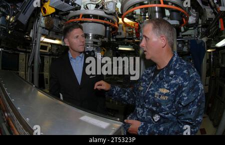 1007287705S-017 NORFOLK (July 28, 2010) Cmdr. Paul Whitescarver, commanding officer of the Los Angeles-class attack submarine USS Scranton (SSN 756), explains control room operations to Juan M. Garcia III, Assistant Secretary of the Navy for Manpower and Reserve Affairs, during a tour of the ship. Garcia was in the Hampton Roads area for a conference and to visit with military leaders. Stock Photo