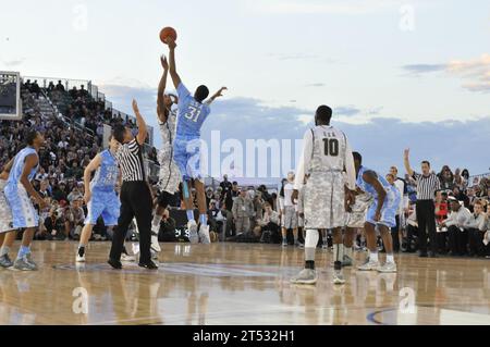 111111OK922-108 SAN DIEGO (Nov. 11, 2011) University of North Carolina center John Henson gets the jump on Michigan State University center Adreian Payne and tips the basketball to Tar Heel forward Tyler Zeller to start the Quicken Loans Carrier Classic aboard the Nimitz-class aircraft carrier USS Carl Vinson (CVN 70). Carl Vinson is hosting Michigan State University and the University of North Carolina for an NCAA basketball game. Stock Photo