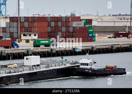 San Pedro, California, USA. 9th May, 2015. The ''Vicki Ann'' pusher tug passing by stacked containers at the cargo container terminal at the Port Of Los Angeles. (Credit Image: © Ian L. Sitren/ZUMA Press Wire) EDITORIAL USAGE ONLY! Not for Commercial USAGE! Stock Photo