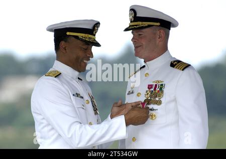 0808018467N-001 GROTON, Conn. (Aug. 1, 2008) Rear Adm. Bruce E. Grooms, left, presents Capt. David M. Hendricks with the Meritorious Service Medal at the Regional Support Group Groton change of command. Hendricks is relieved by Capt. Douglas E. Arnold during a ceremony aboard the historic submarine USS Nautilus (SSN 571) at the U.S. Navy Submarine Force Museum. (U.S. Navy Stock Photo