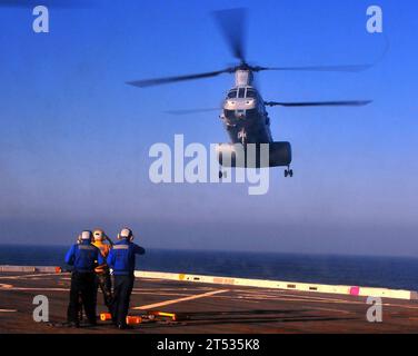 0812064774B-198 PACIFIC OCEAN (Dec. 6, 2008) Members of the flight deck crew aboard the amphibious transport dock ship USS New Orleans (LPD 18) signal to an approaching CH-46E helicopter assigned to the 'Evil Eyes' of Marine Medium Helicopter Squadron (HMM) 163 (REIN). New Orleans is on a certification exercise as part of the Boxer Expeditionary Strike Group in preparation for an upcoming deployment. Stock Photo