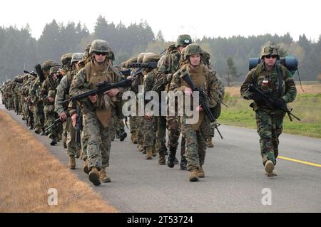 1010252143T-002  JOINT BASE LEWIS-MCCHORD, Wash. (Oct. 25, 2010) Sailors and Marines assigned to Marine Corps Security Force Battalion carry their battle gear on a seven-mile march as part of combined force-on-force training. More than 150 Sailors and Marines took part in the weeklong field training exercise, which focused on military operations in urban terrain, urban patrolling, building assaults and room clearing. Stock Photo
