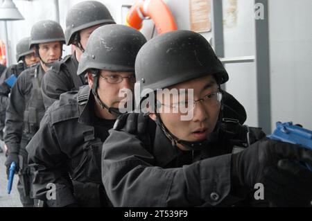 A U.S. Navy boarding team practices tactical movements aboard the USS ...